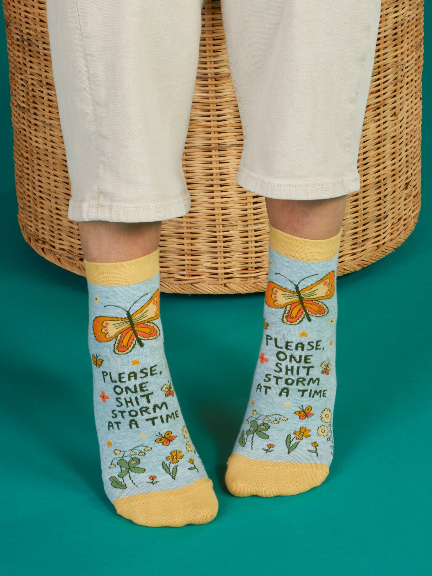 Blue Q ankle socks featuring a colorful "Shitstorm" design, made from soft fabric for comfortable wear.