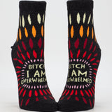 Blue Q ankle socks featuring a design with the phrase "Bitch I AM Overwhelmed" in bold lettering, casual and comfortable footwear.