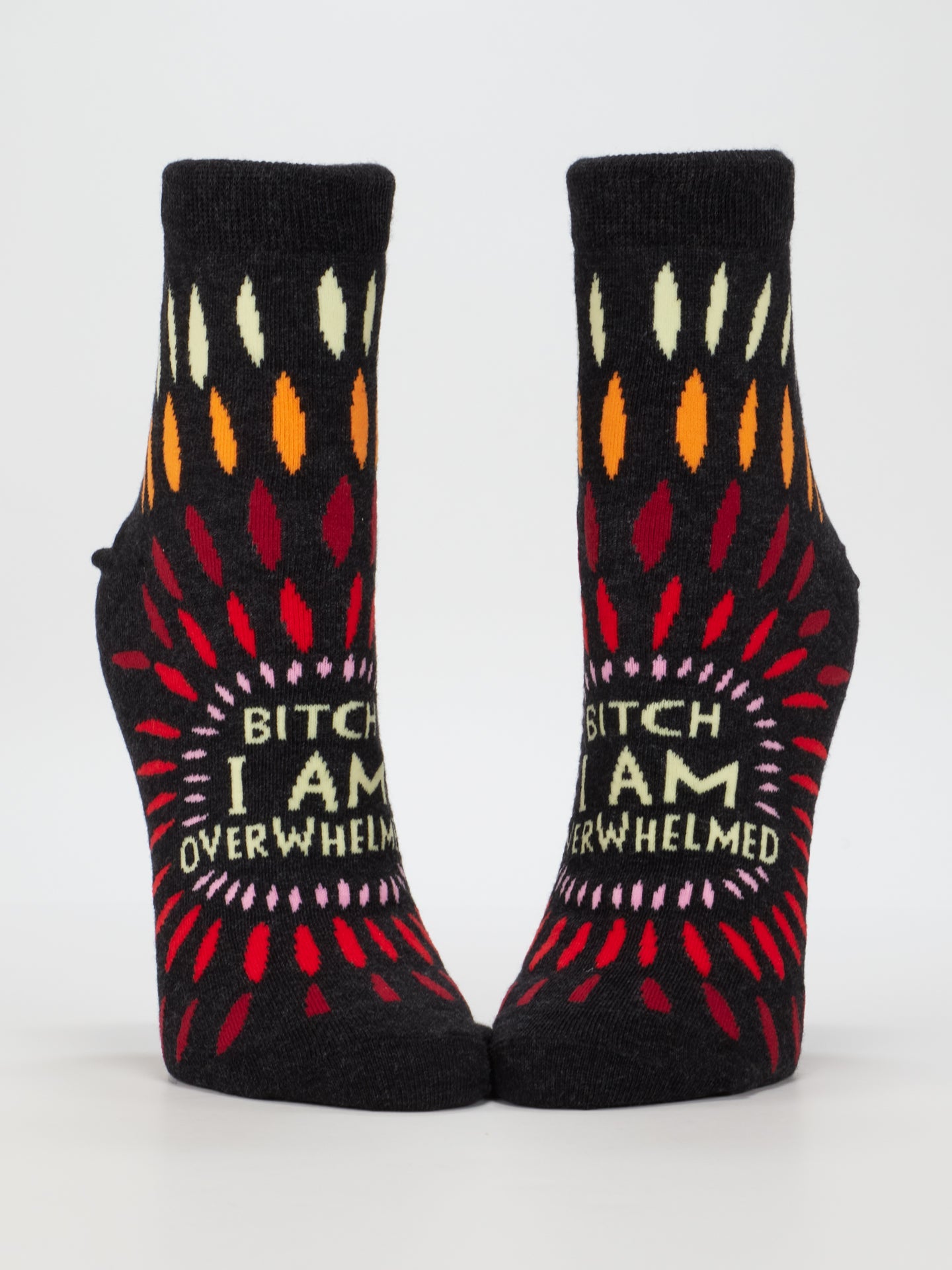 Blue Q ankle socks featuring a design with the phrase "Bitch I AM Overwhelmed" in bold lettering, casual and comfortable footwear.
