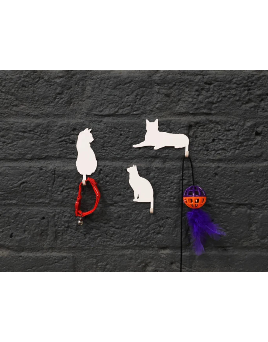 Suck UK Hooks Cat wall hooks shaped like playful cats, black color, mounted on a white wall for functional and decorative use.