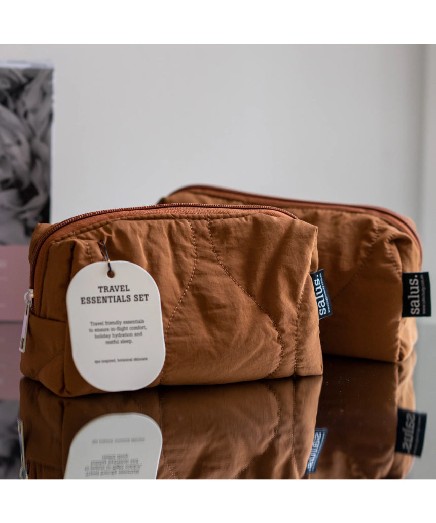 Say It Sister Salus travel essentials set with compact toiletries, skincare bottles, and accessories for convenient travel organization.