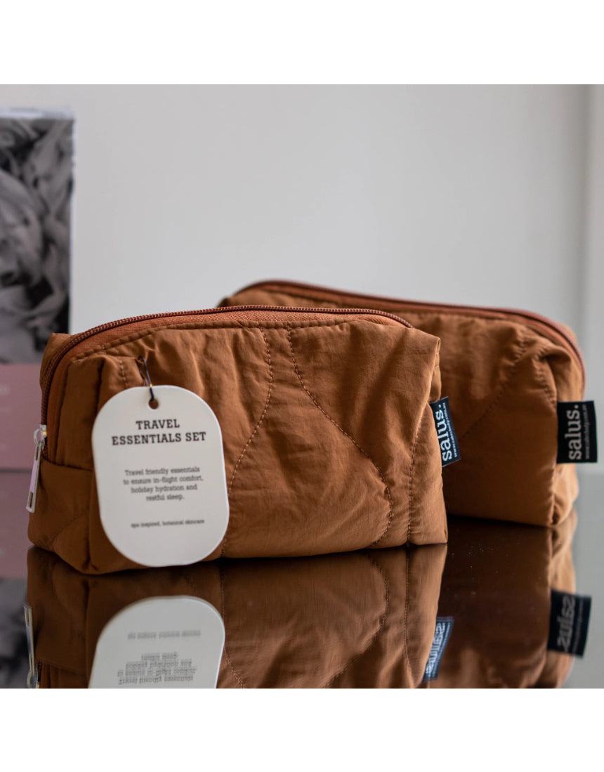 Say It Sister Salus travel essentials set with compact toiletries, skincare bottles, and accessories for convenient travel organization.
