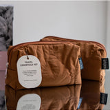 Say It Sister Salus travel essentials set with compact toiletries, skincare bottles, and accessories for convenient travel organization.
