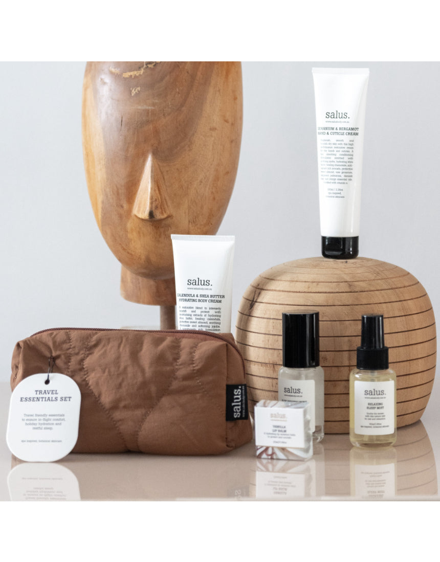 Say It Sister Salus Travel Essentials Set with compact skincare bottles and accessories on a white background.