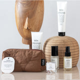 Say It Sister Salus Travel Essentials Set with compact skincare bottles and accessories on a white background.