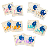 Lula Self-Warming Eye Mask Mixed Pack with 10 masks, soft fabric covering closed eyes for soothing relaxation and warmth.