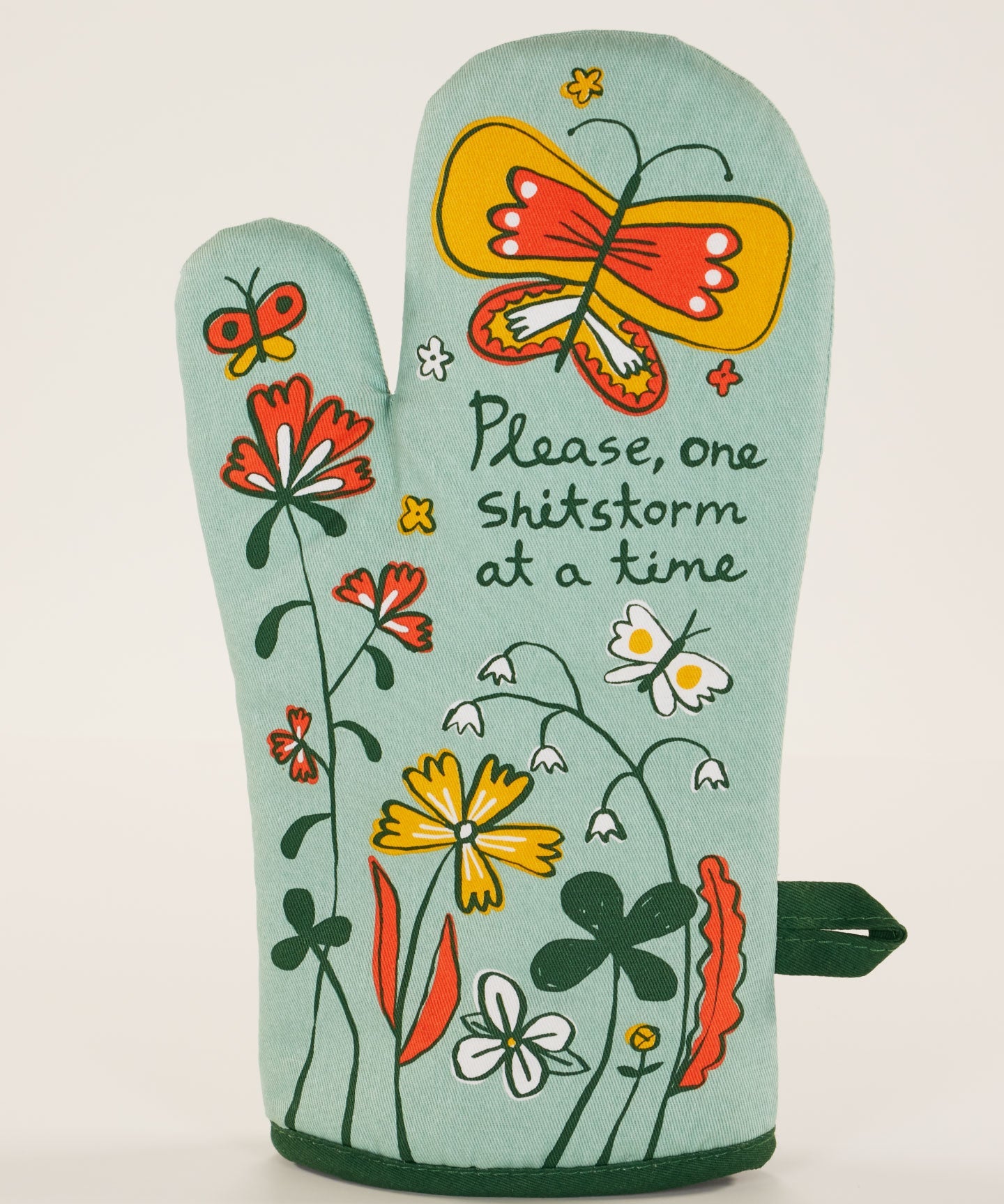 Blue Q oven mitt featuring a colorful "Shitstorm" design, made of heat-resistant fabric for kitchen safety and style.