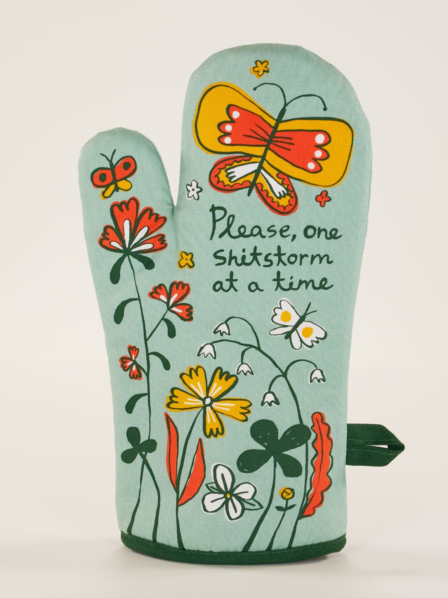 Blue Q oven mitt featuring a colorful "Shitstorm" design, made of heat-resistant fabric for kitchen safety and style.