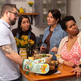 Blue Q oven mitt featuring a colorful "Shitstorm" design, made for hot handling in the kitchen, with a vibrant, playful pattern.