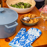 Blue Q oven mitt with colorful party in the kitchen design, heat-resistant fabric for cooking and baking protection.