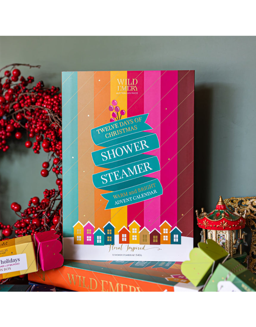 Wild Emery warm and bright Christmas shower steamer advent calendar with 12 festive shower bombs in colorful packaging