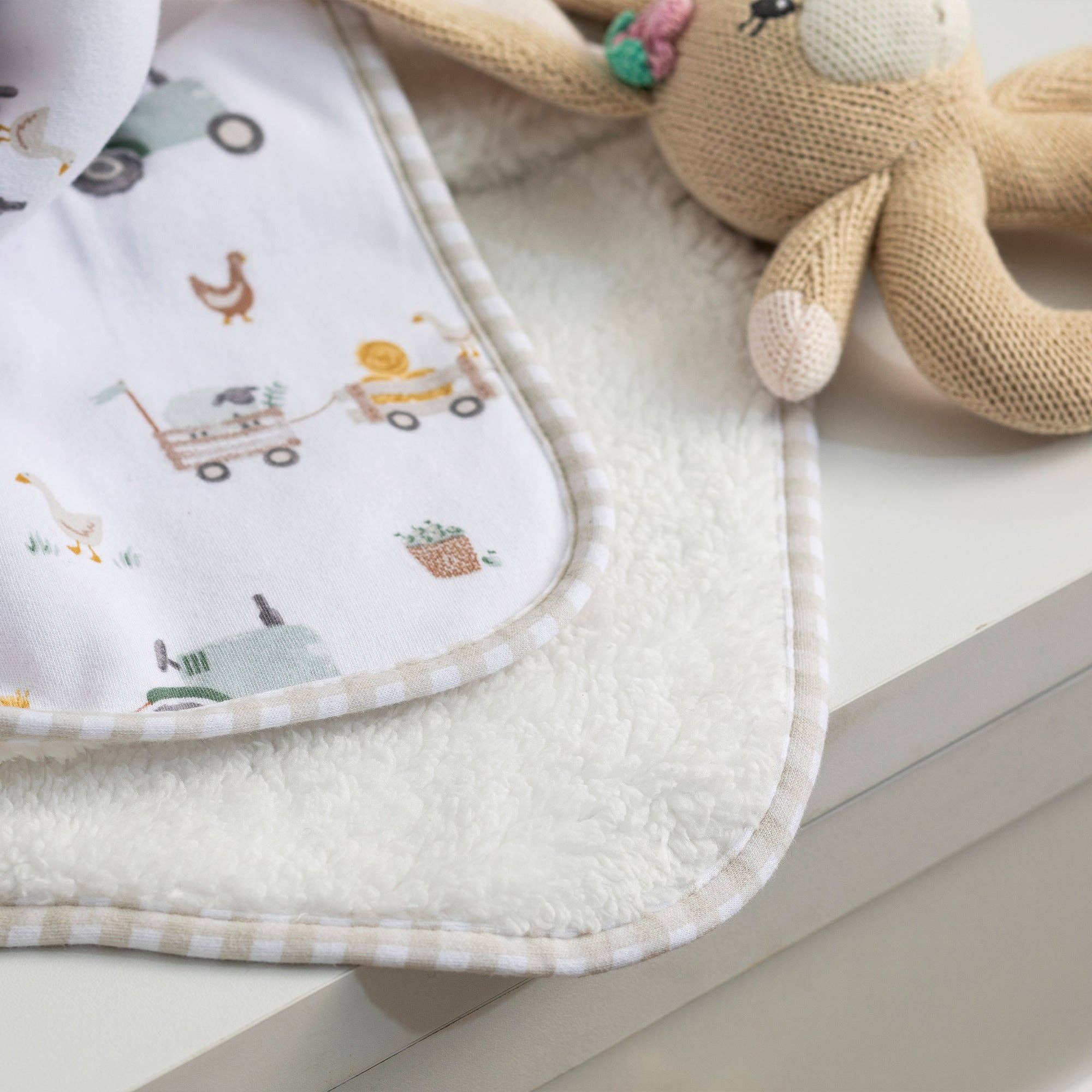 Living Textiles Jersey Sherpa Blanket featuring a tractor ride print, soft and cozy for children.