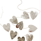 Reversible faux-tin heart bunting in light dusty pink by THE LITTLE PRESS, hanging display of decorative hanging banners.