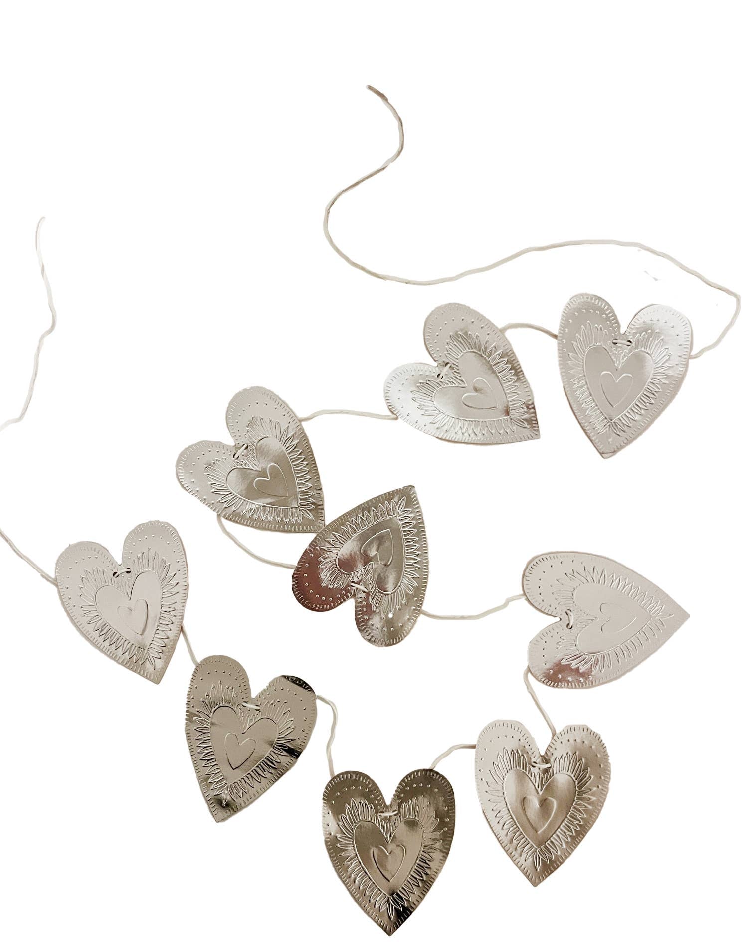Reversible faux-tin heart bunting in light dusty pink by THE LITTLE PRESS, hanging display of decorative hanging banners.
