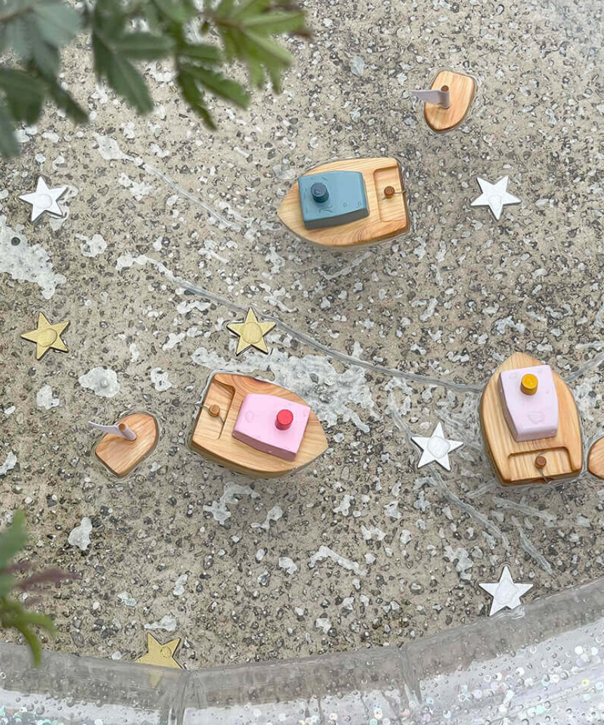 Pink Ofune wind-up boat for kids by Axis Toys, shown floating on water with detailed pink and white design.