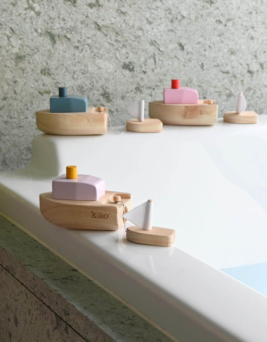 Pink wind-up boat toy for kids from Axis Toys, featuring a small pink boat with a wind-up mechanism.