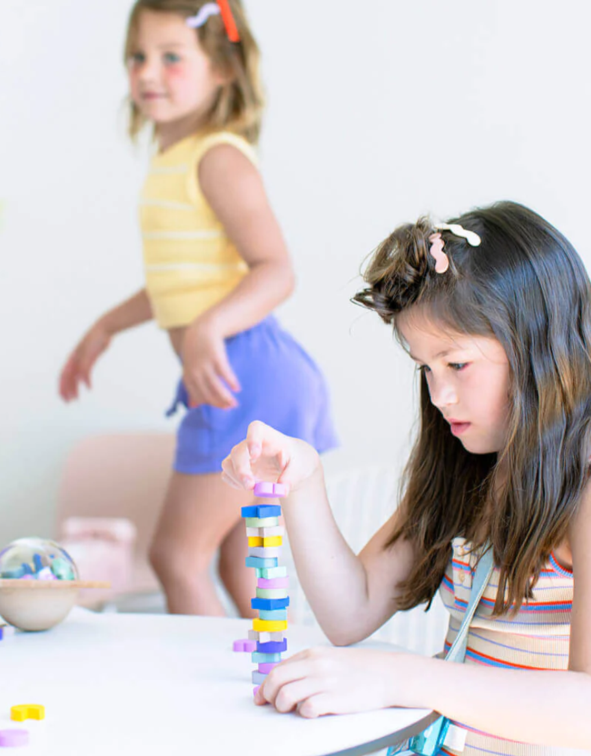 Kids UFO Balance Game by Axis Toys showing colorful plastic pieces and game components on a play surface.