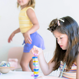 Kids UFO Balance Game by Axis Toys showing colorful plastic pieces and game components on a play surface.