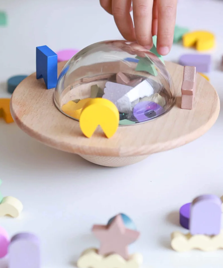 Kids playing with the Axis Toys UFO Balance Game, a colorful kids' balancing game with a UFO theme.