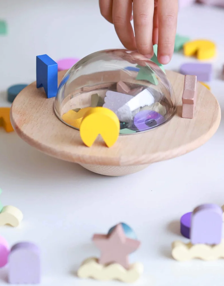 Kids playing with the Axis Toys UFO Balance Game, a colorful kids' balancing game with a UFO theme.