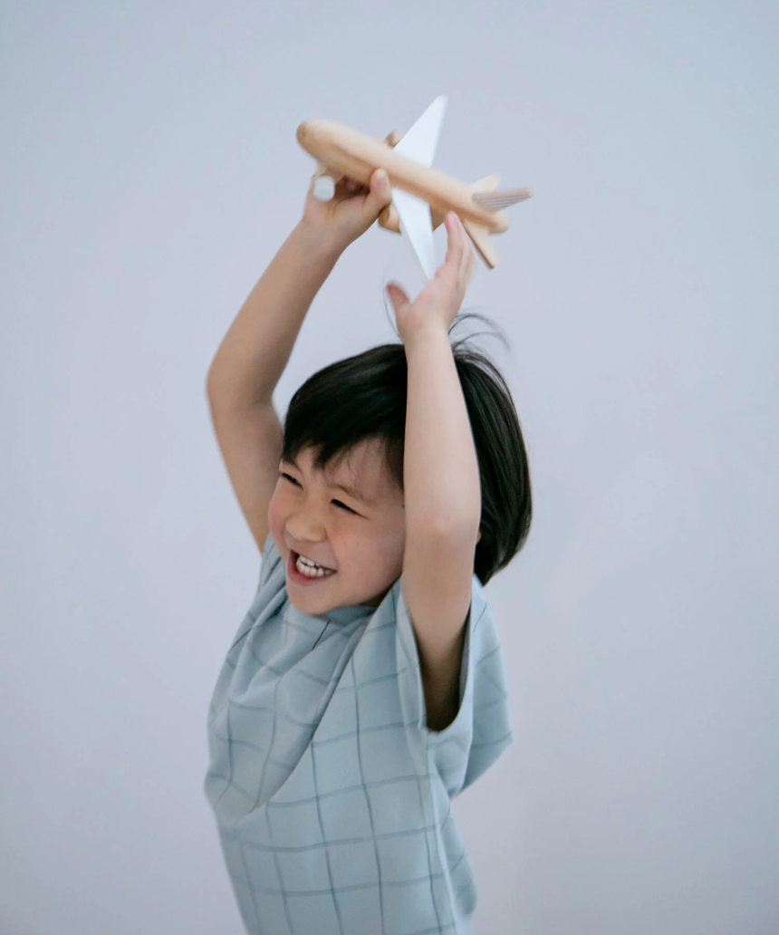 Black wooden wind-up jet plane toy for kids by Axis Toys, with detailed craftsmanship and sleek design.