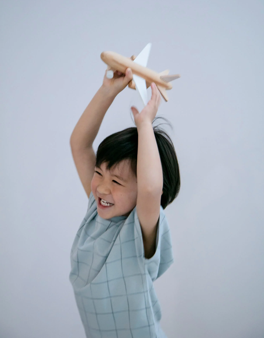 Black wooden wind-up jet plane toy for kids by Axis Toys, with detailed craftsmanship and sleek design.