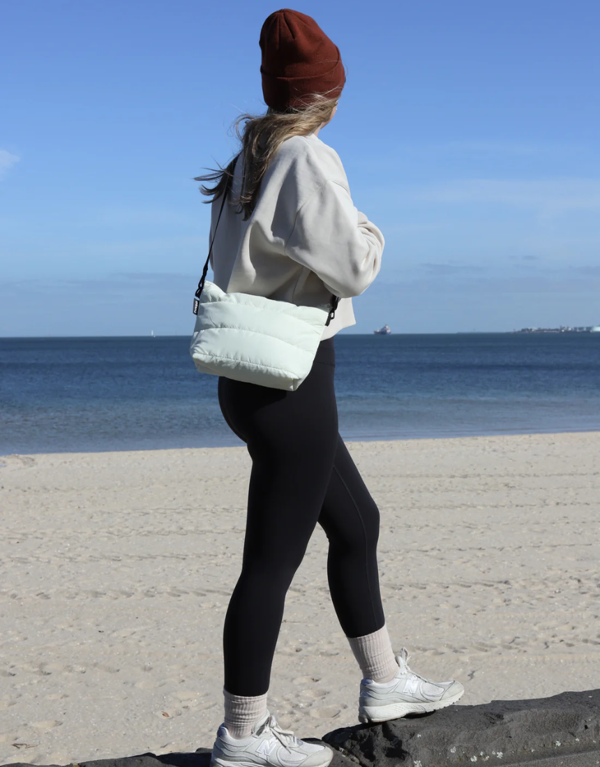 Ecru Crossbody Bag by Base with cloud design, featuring a compact, stylish shape and adjustable strap for everyday use.
