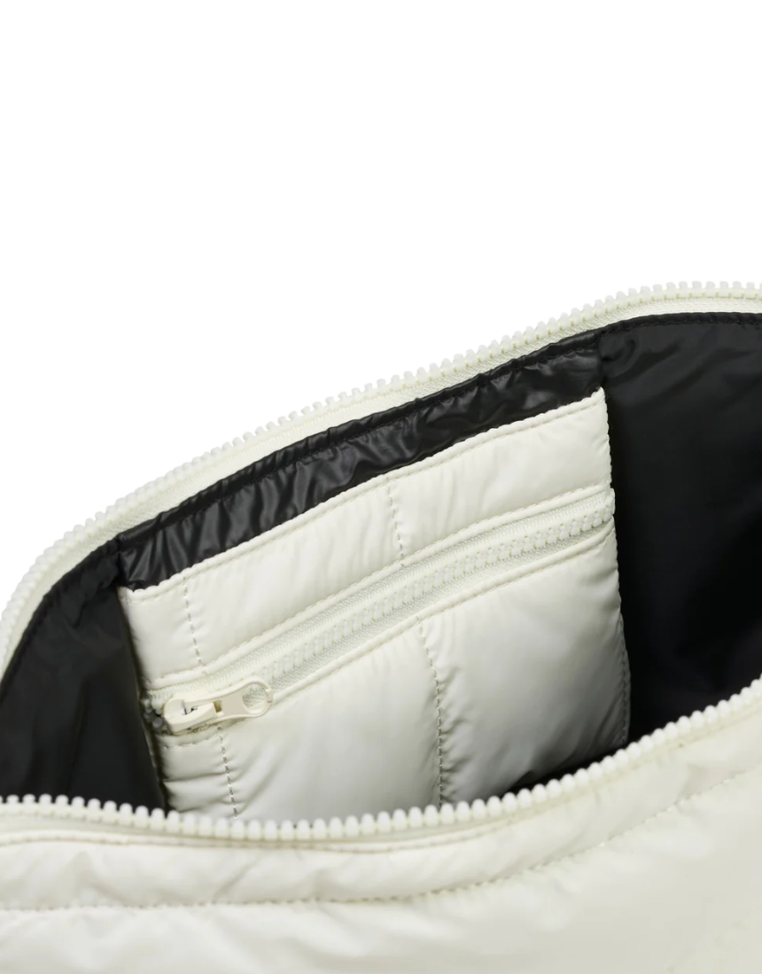 Ecru Base Cloud Stash Crossbody bag with adjustable strap and minimalist design, made of soft fabric for everyday use.