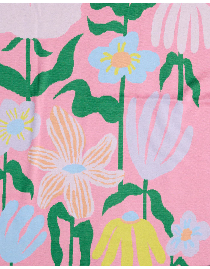 Green Kip & Co cotton knitted blanket with colorful popping flower pattern, soft and cozy for home bedding or lounging.
