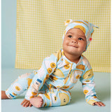 Baby wearing a Halcyon Nights Brunch Buddies long sleeve zip suit with a matching hat, featuring colorful brunch-themed patterns.