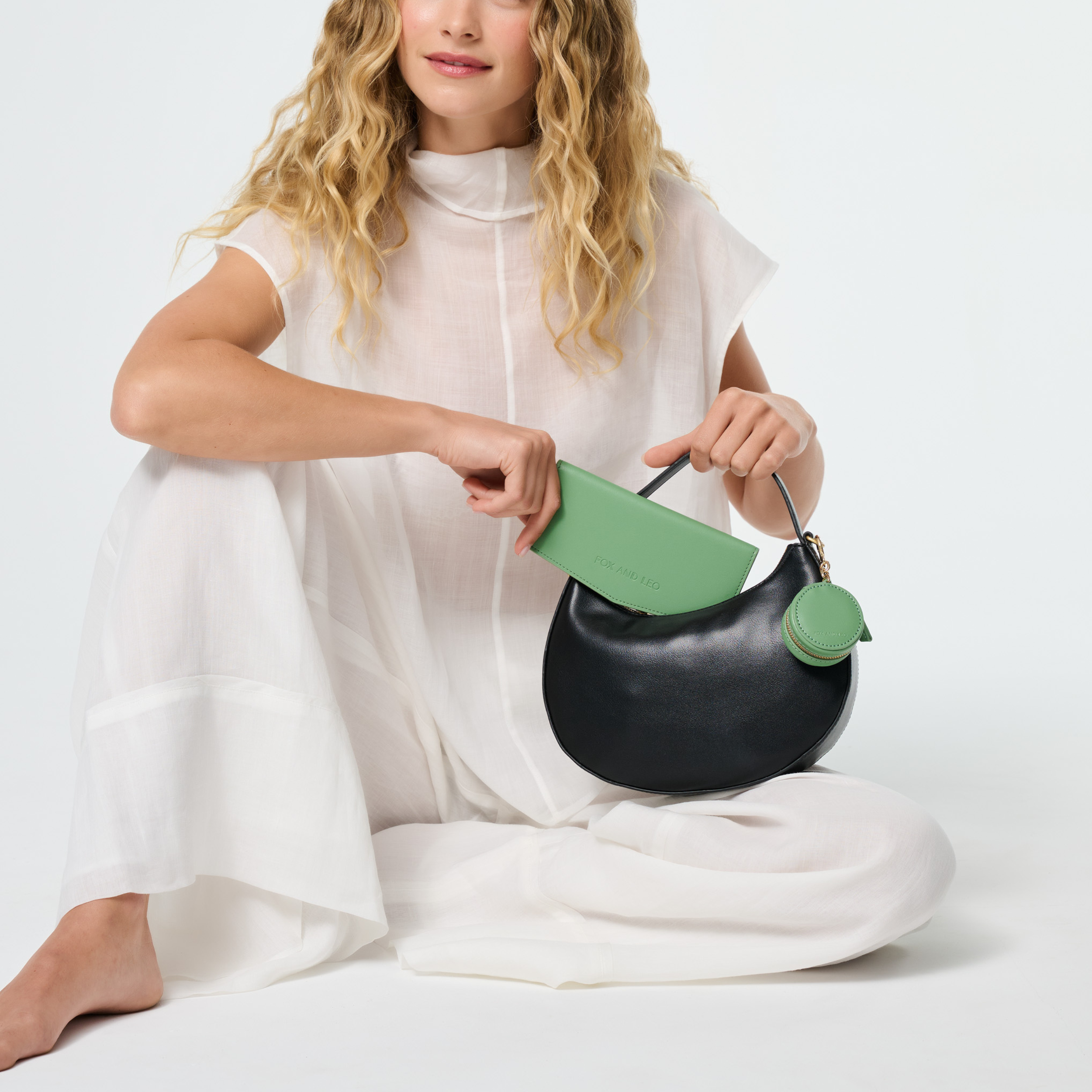 Fox & Leo The Swallet in sage, a stylish and cozy knitted sweater featuring a textured pattern and ribbed cuffs.