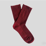 Cherry red Klue glitter lurex socks with a shiny, sparkly finish and ribbed cuffs, perfect for adding a pop of color to your outfit.