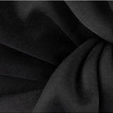Black Olga Berg Chloe front tie clutch bag with sleek design and elegant front tie detail.