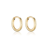 Gold Linda Tahija classic huggie earrings with smooth, rounded design, close-fitting earring hoops for pierced ears.
