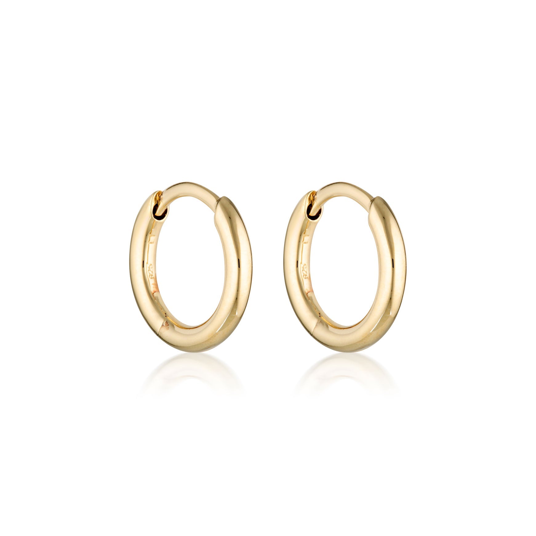 Gold Linda Tahija classic huggie earrings with smooth, rounded design, close-fitting earring hoops for pierced ears.