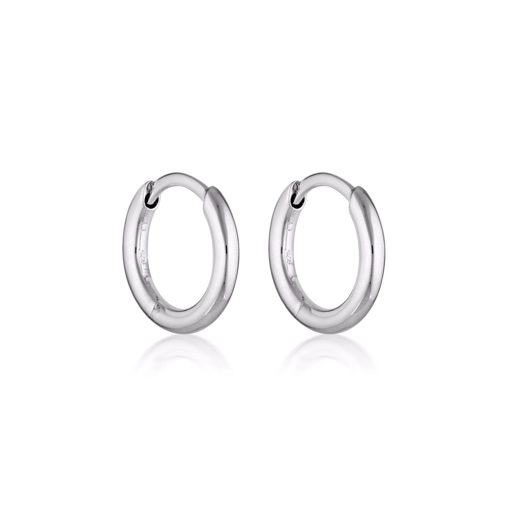 Silver Linda Tahija Classic Huggie Earrings featuring simple, sleek hoop design for everyday wear.