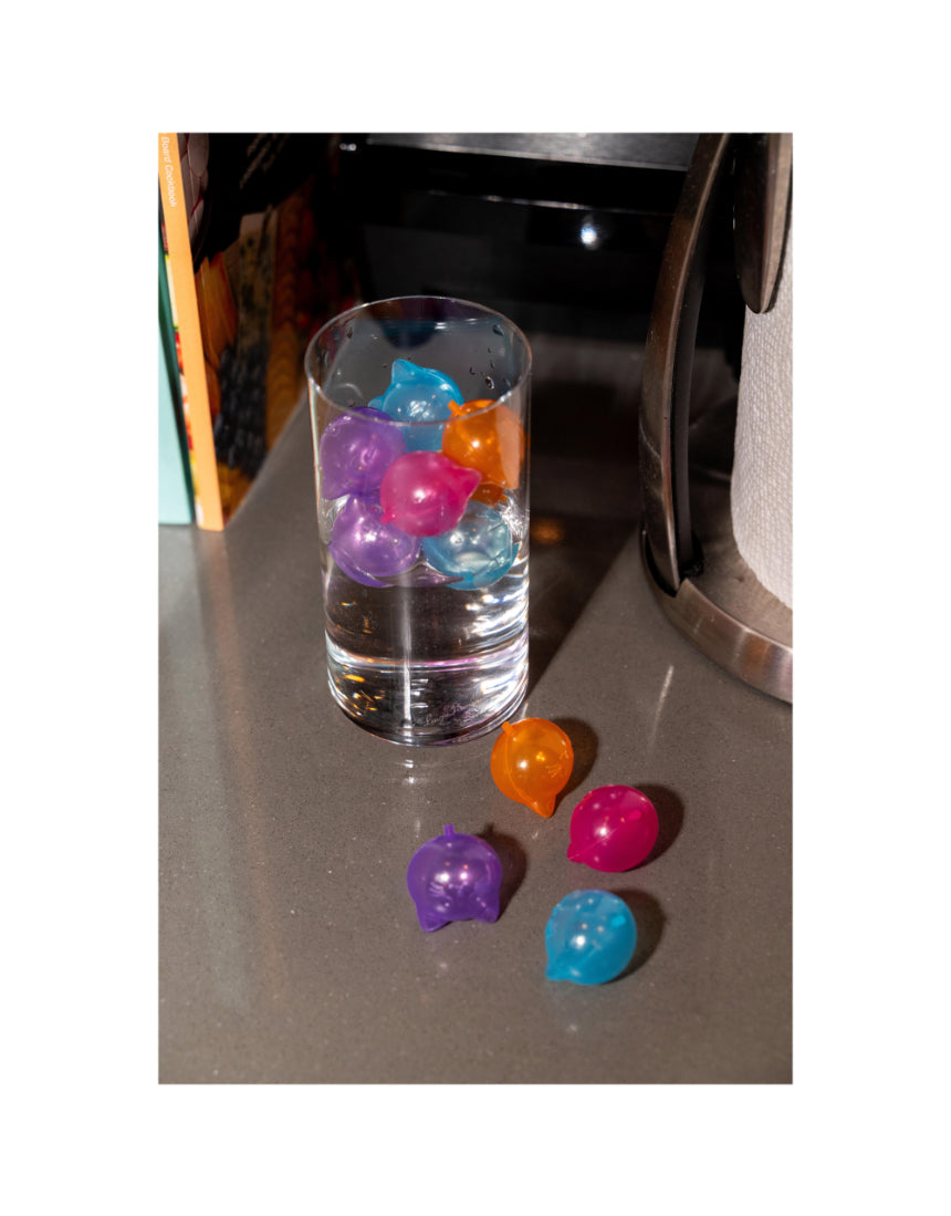 Set of 24 reusable cat ice cubes by isAlbi, showing clear silicone molds filled with water for keeping cats cool.