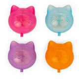 Set of 24 reusable cat ice cubes from isAlbi, displayed in a clear container with some ice cubes and a playful cat in the background.