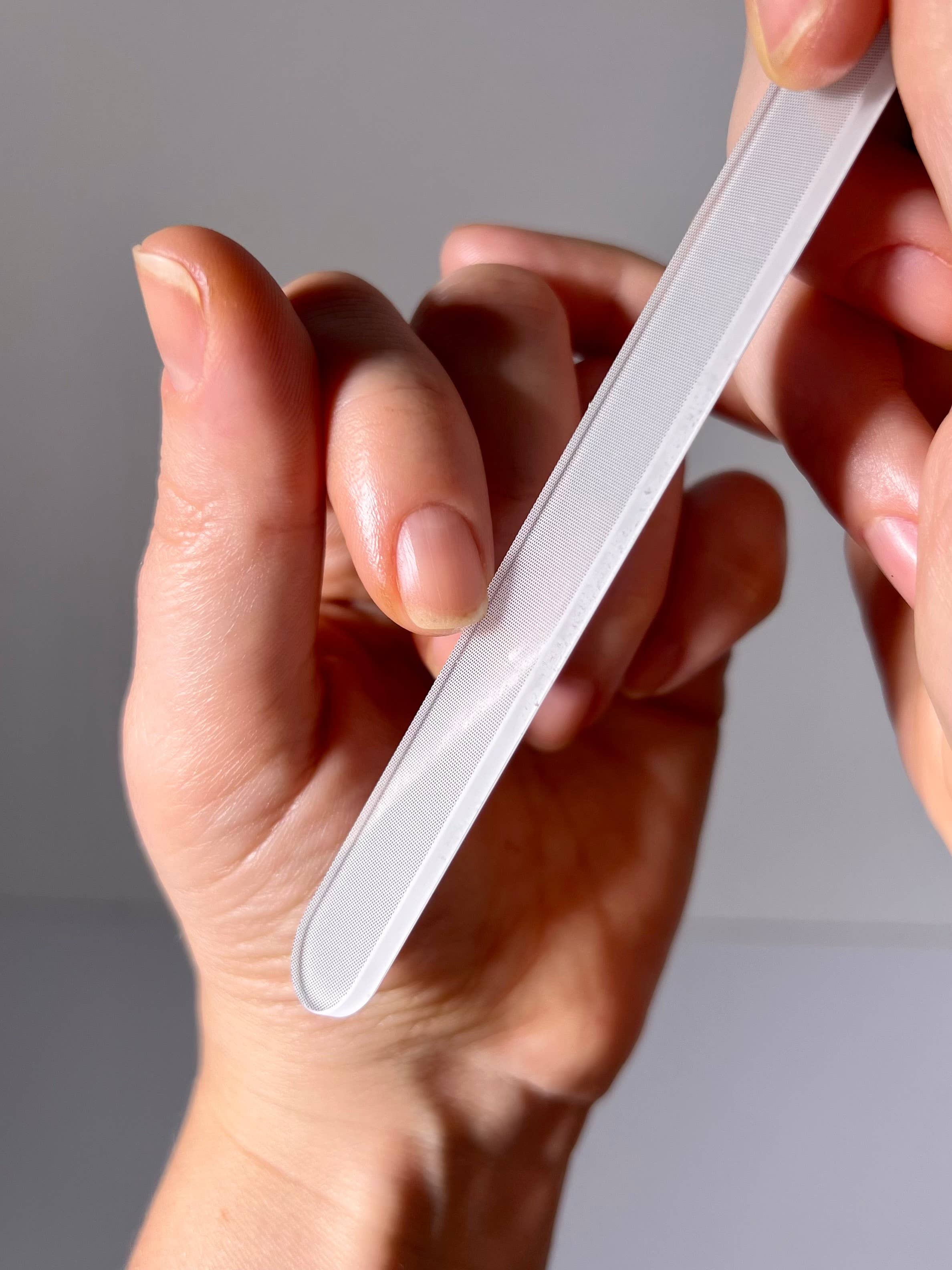 Hanami Nano Glass Nail File and Buffer showing a sleek, clear glass nail file with a textured surface for smoothing nails.