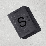 Solid State Supreme Solid Cologne in a sleek container, showcasing the compact, travel-friendly design and premium branding.