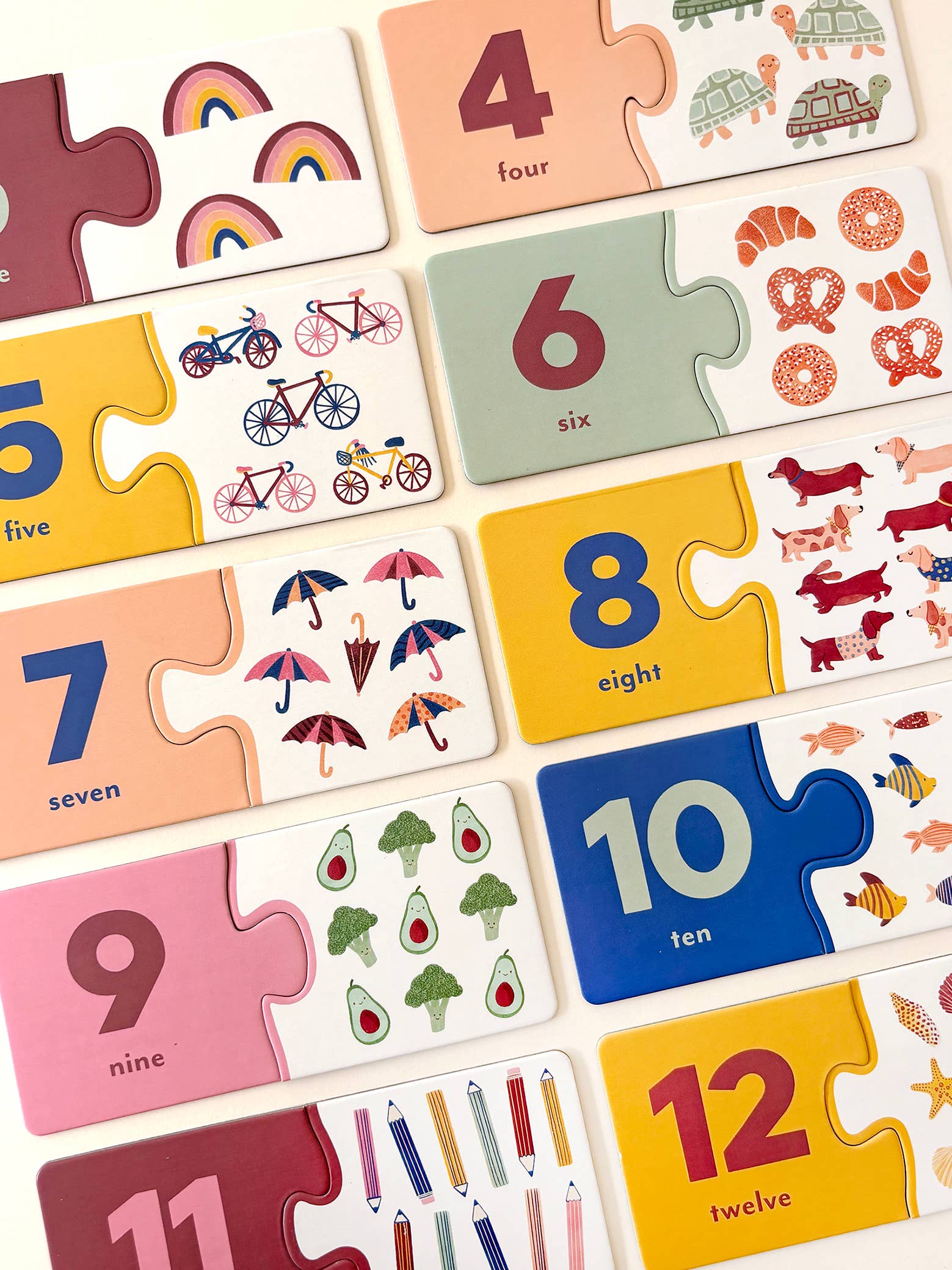 Lauren Sissons Studio Number Puzzle Pairs featuring colorful, interconnected puzzle pieces with numbers for educational play and visual appeal.
