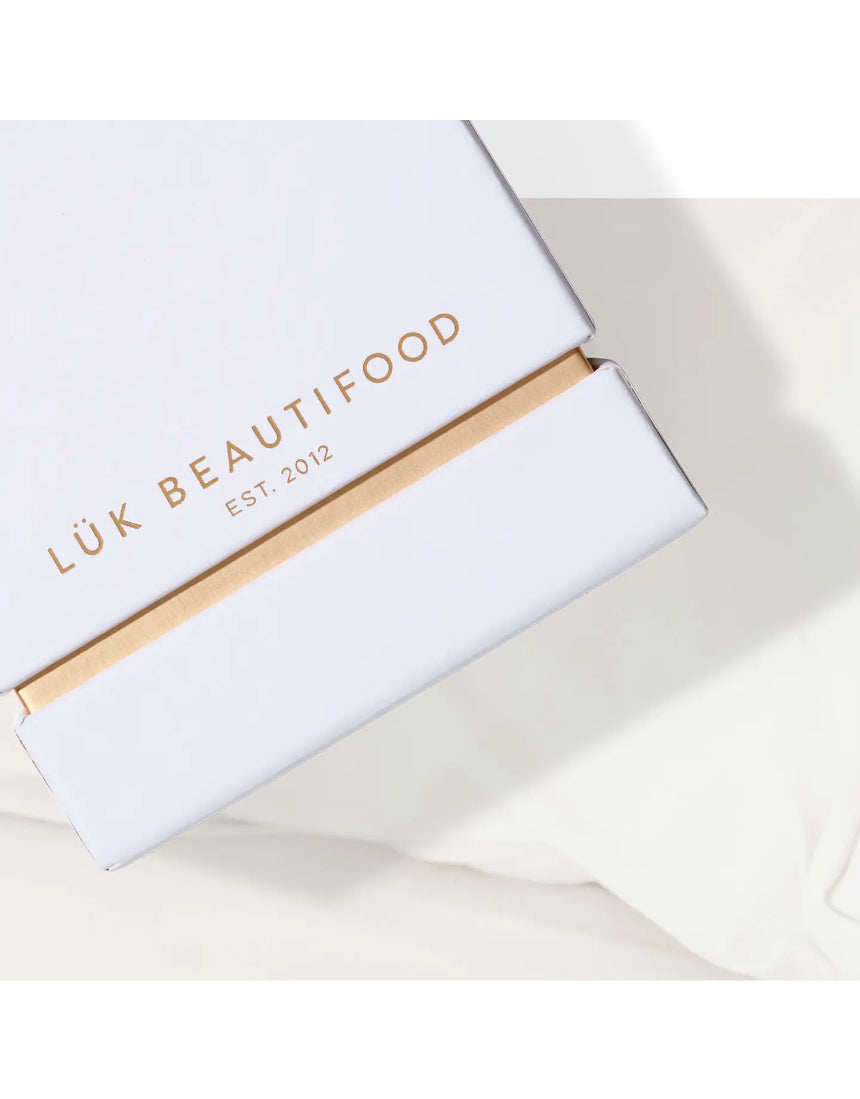 Lük Beautifood Lip Nourish Trio with three nude-colored lip balms in sleek containers, perfect for natural, moisturized lips.
