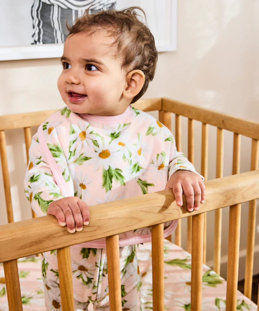 Kip & Co Sweet Daisy cotton baby bib with colorful daisy pattern on soft fabric, designed for gentle feeding and drool protection.