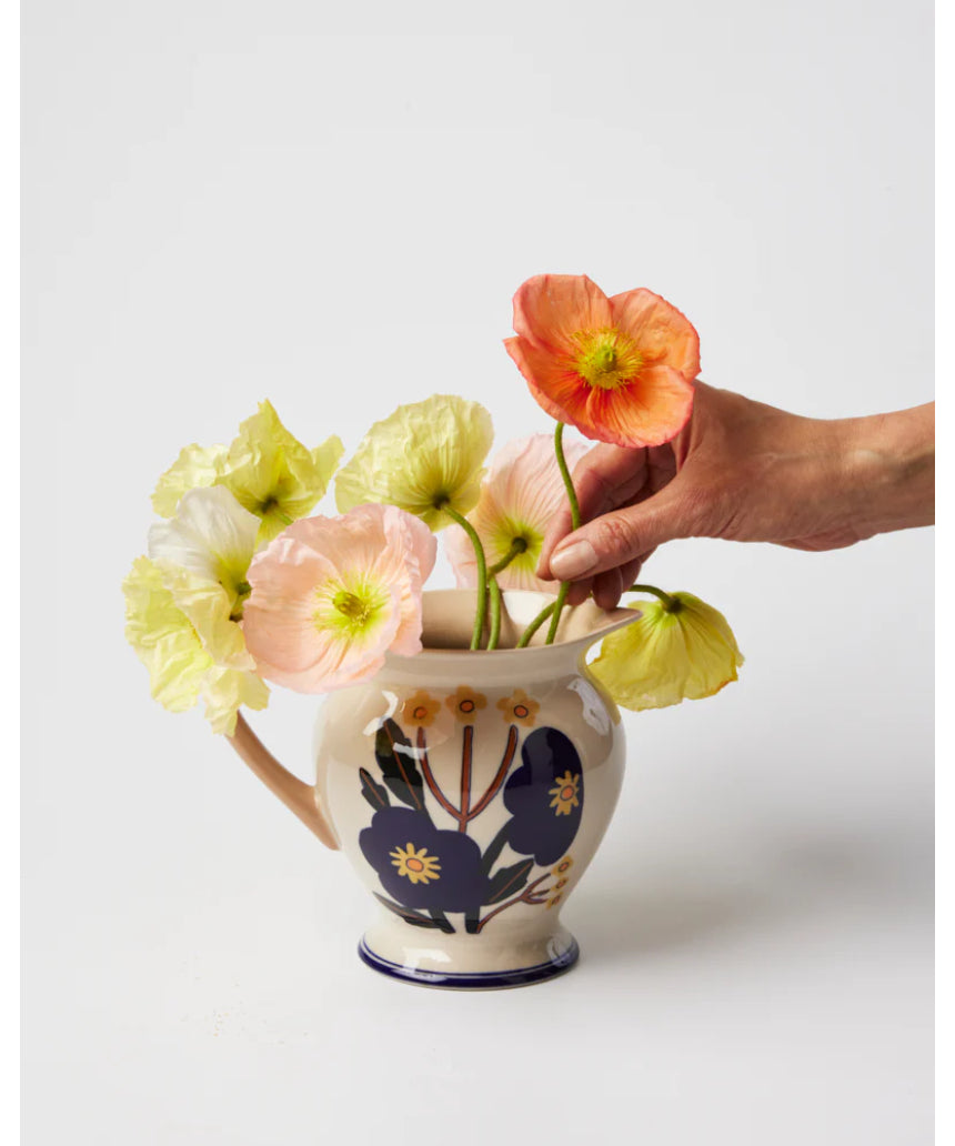 Jones & Co blue floral vase with a pitcher shape, featuring a vibrant bloom design and elegant ceramic finish.