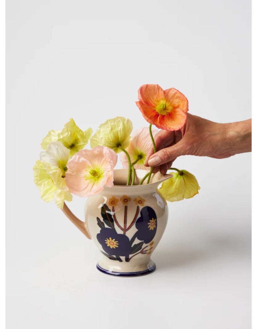 Jones & Co blue floral vase with a pitcher shape, featuring a vibrant bloom design and elegant ceramic finish.