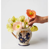 Jones & Co blue floral vase with a pitcher shape, featuring a vibrant bloom design and elegant ceramic finish.