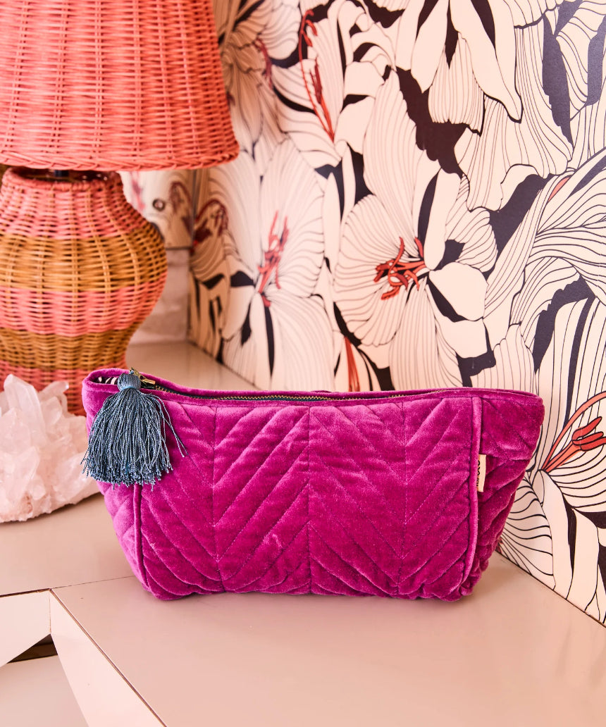 Kip & Co Wild Grape velvet toiletry bag showing its soft, textured fabric and compact shape for travel accessories.