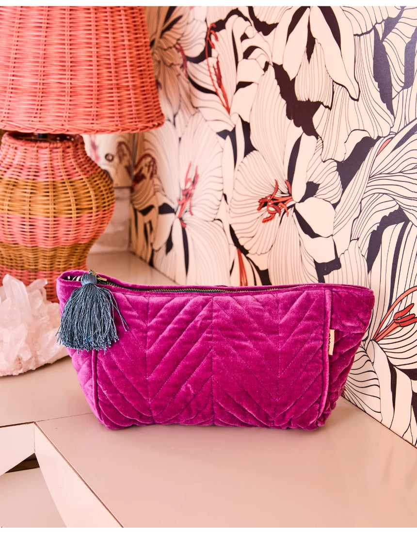Kip & Co Wild Grape velvet toiletry bag showing its soft, textured fabric and compact shape for travel accessories.