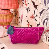 Kip & Co Wild Grape velvet toiletry bag showing its soft, textured fabric and compact shape for travel accessories.