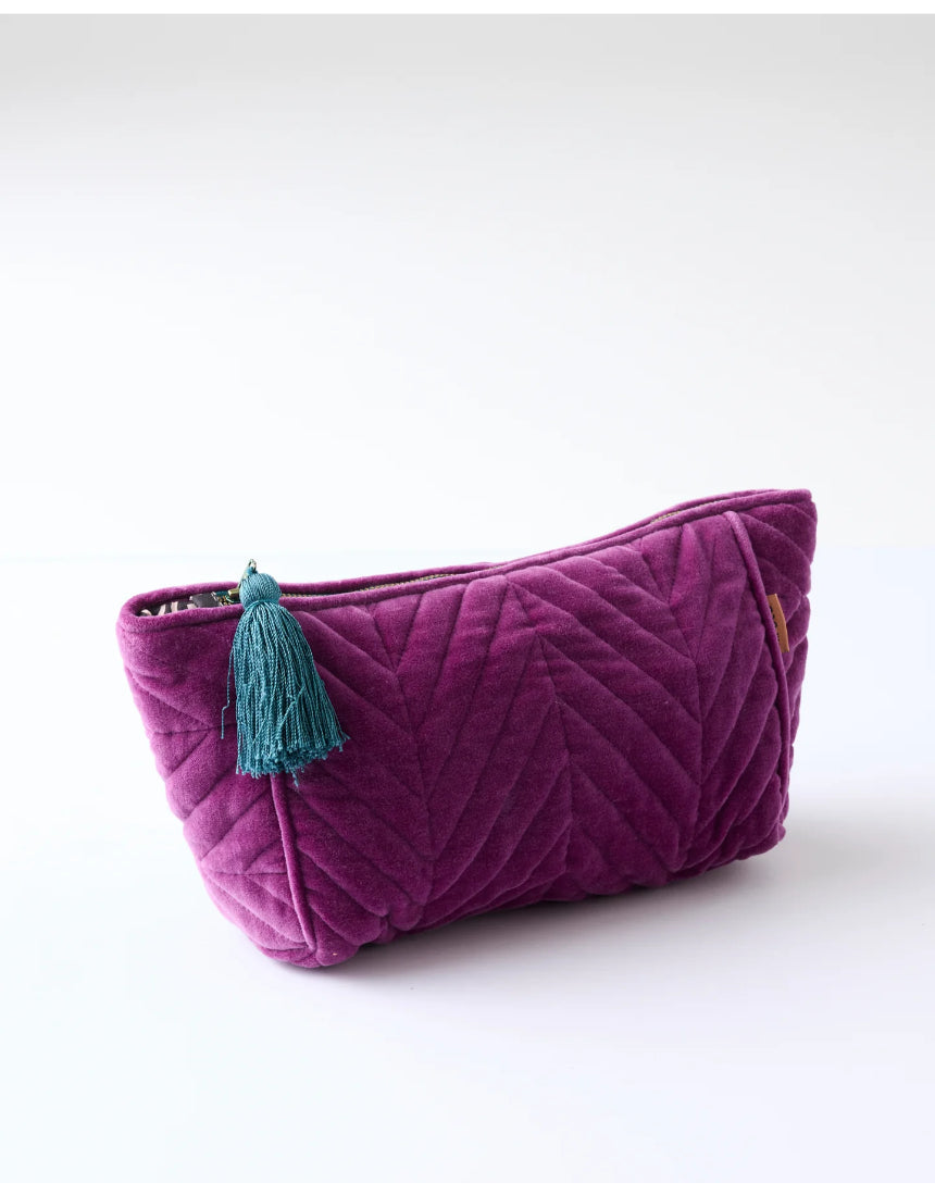 Kip & Co Wild Grape velvet toiletry bag with zipper closure, soft plush fabric, and compact design for travel accessories.